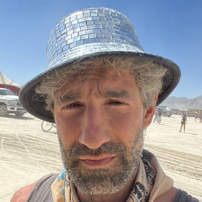 Tair Mamedov on the playa in a mirrored bucket hat
